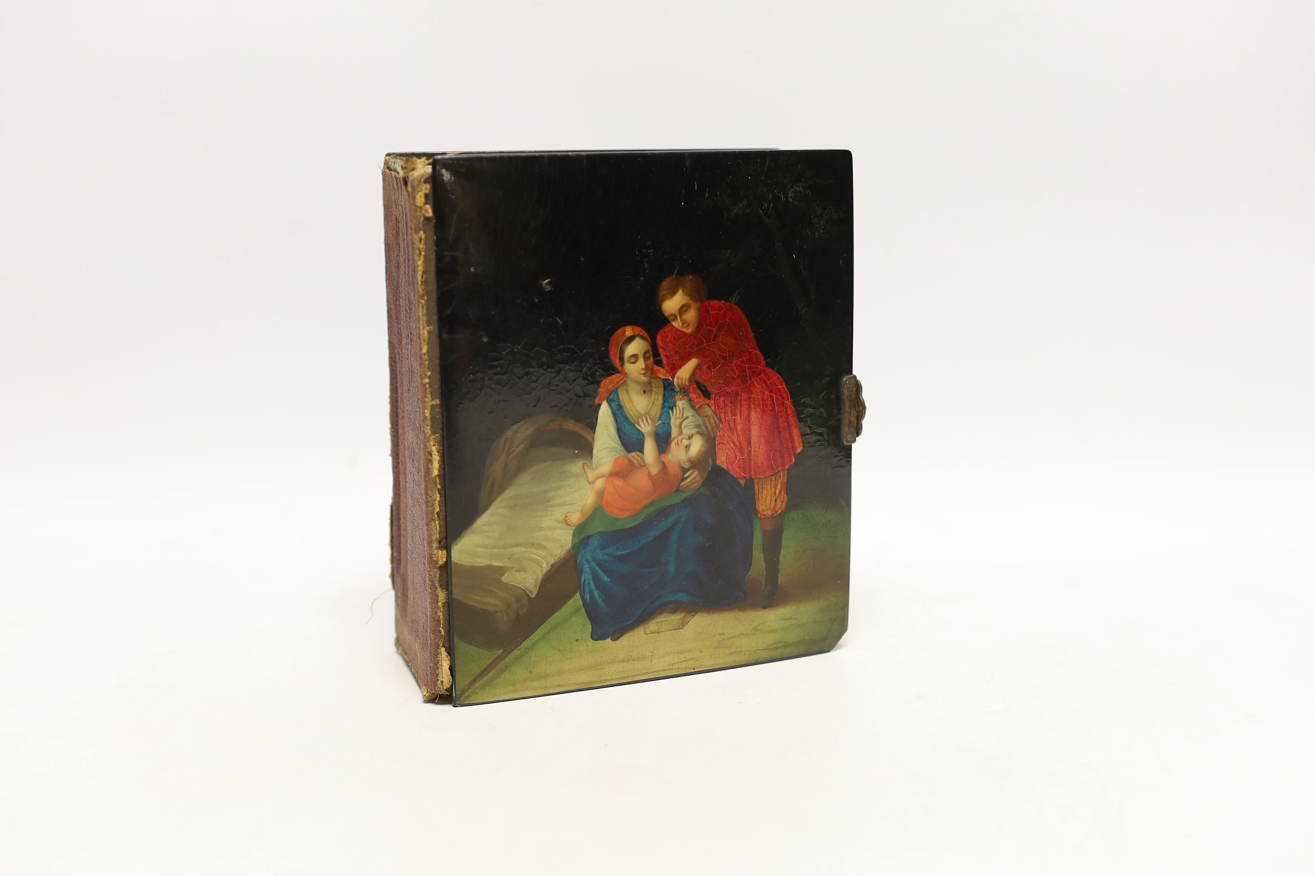 A Russian lacquer boarded photograph album, Lukutin, late 19th century, decorated with a couple and child, containing Victorian photographs, 16 cm x 13.5cm, Please note this lot attracts an additional import tax of 5% on